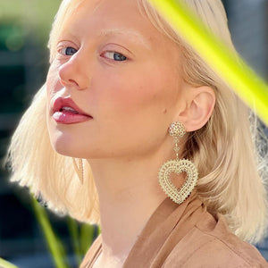 Model Wearing Filienna 14K Gold Heart Statement Earrings in Yellow Gold
