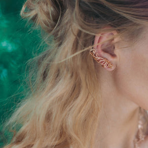 The model is wearing Baby B Climber Earrings with stud backs in rose gold toned blush silver