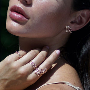 Model wearing the trillium collection stud earrings and cocktail ring. 